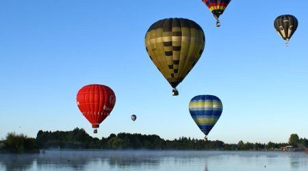 Landscape image of hot multiple hot air balloons in the sky
